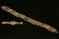 Lot 491 - An Edwardian four-row gold gate bracelet