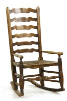 Lot 639 - An ash ladder back rocking chair