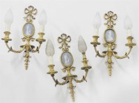 Lot 480 - A set of three gilt metal twin branch wall light