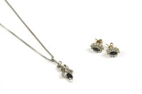 Lot 15 - A pair of gold diamond and sapphire cluster earrings