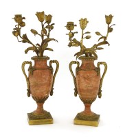 Lot 812 - A pair of pink marble and ormolu candelabra