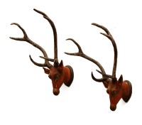 Lot 706 - A pair of large carved wooden and painted Indian-style stag trophy heads