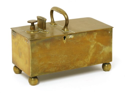 Lot 505 - A brass tavern honesty box
with a central handle flanked by a coin slot