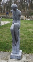 Lot 545 - A granite figure on a plinth