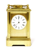 Lot 830 - A miniature mignonette brass carriage clock