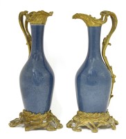 Lot 298 - A pair of French ormolu-mounted porcelain ewers