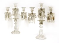 Lot 293 - A pair of Baccarat crystal three-branch candelabra