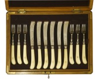 Lot 172 - A set of twelve pairs of ivory-handled silver fruit knives and forks
