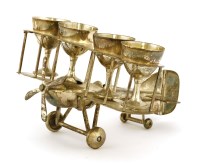 Lot 245 - A silver-plated biplane holding four egg cups