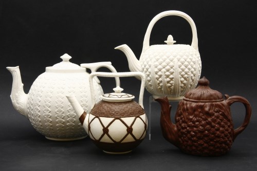 Lot 402 - Four moulded stoneware teapots and covers