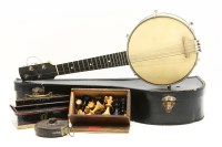 Lot 442 - A banjolele in case with engraved back plate