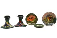 Lot 313 - A pair of Moorcroft Hibiscus candlesticks