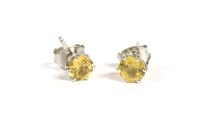 Lot 23 - A pair of white gold single stone yellow sapphire earrings
