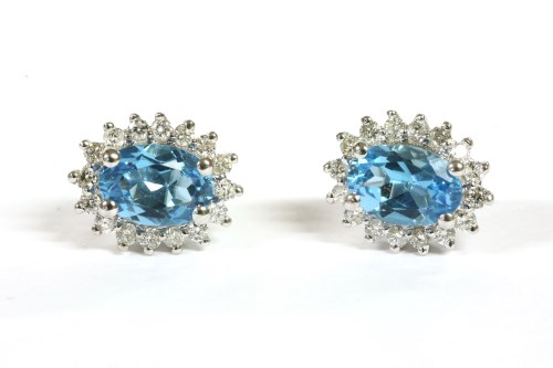 Lot 29 - A pair of white gold topaz cluster earrings
