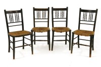 Lot 625 - A set of four ebonised and rush seated side chairs