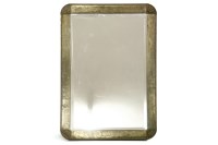 Lot 573 - An Art Deco design brass hammered bevelled mirror