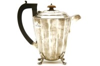 Lot 136 - A silver coffee pot of facetted ovoid form on four paw feet