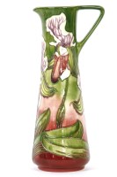Lot 181 - A Moorcroft pottery jug in the Himalayan Orchid pattern designed by Philip Gibson