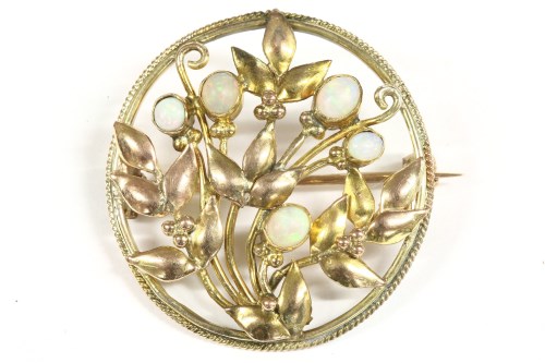Lot 22 - An Arts and Crafts style opal set circular brooch