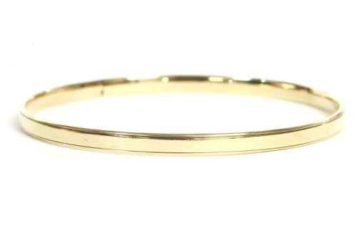 Lot 28 - A 9ct gold solid flat section slave bangle