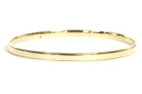 Lot 28 - A 9ct gold solid flat section slave bangle