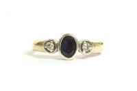 Lot 30 - A 9ct gold three stone sapphire and diamond ring