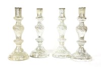 Lot 535 - A set of four silvered glass candlesticks