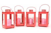 Lot 523 - A set of four pink painted candle lanterns