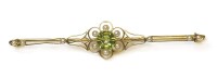 Lot 316 - An cased Edwardian gold peridot and seed pearl bar brooch