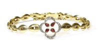 Lot 335 - A gold ruby and diamond quatrefoil bracelet