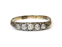Lot 311 - An Edwardian five stone carved head diamond ring