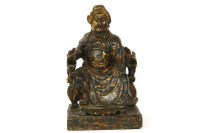 Lot 192 - A Chinese carved wood figure seated