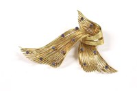 Lot 112 - A gold sapphire set spray ribbon brooch