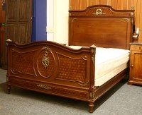 Lot 415 - A late 19th century Louis style walnut and parquetry double bedstead