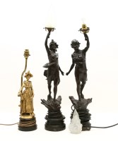 Lot 290 - A pair of spelter figural lamps 'La Paix' and 'La Guerre' each holding aloft the glass flambeau shade