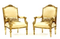 Lot 526 - A pair of French Louis XV style gilt carved open armchairs