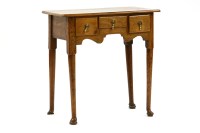 Lot 509 - A George III oak lowboy