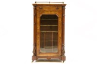 Lot 499 - A Victorian figured walnut pier cabinet with single glazed door flanked by plinths
