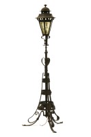 Lot 514 - An Arts and Crafts wrought iron standard lamp in the form of a street lantern on tripod base
