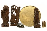 Lot 194 - Six Japanese carved hardwood figures of deities together with two circular brass trays and a soapstone model of a beetle (9)