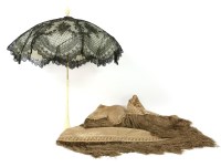 Lot 563 - A black lace parasol with a carved bone handle