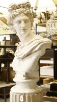 Lot 751 - A white painted plaster bust of a Roman dignitary