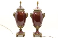 Lot 534 - A pair of rouge porcelain vase form table lamps