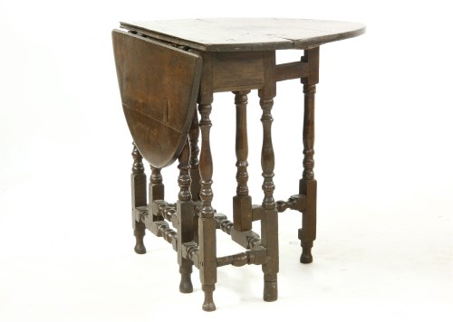 Lot 487 - A small 18th century oval oak gateleg table
