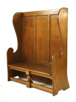 Lot 82 - An Arts and Crafts oak panelled settle
