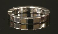 Lot 234 - A white gold Cartier 'Lanieres' flat section band ring