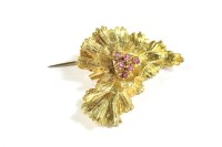 Lot 118 - A gold ruby cluster leaf brooch