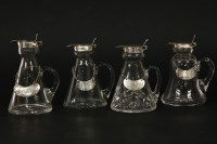 Lot 385 - Four glass whisky tots with mounts and lids