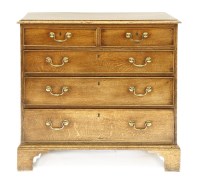 Lot 403 - An 18th century oak chest of two short over three graduated long drawers