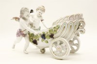 Lot 603 - A large Continental porcelain centrepiece in the form of two cherubs pushing a chariot